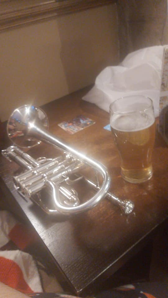a cornet sits next to a pint of beer